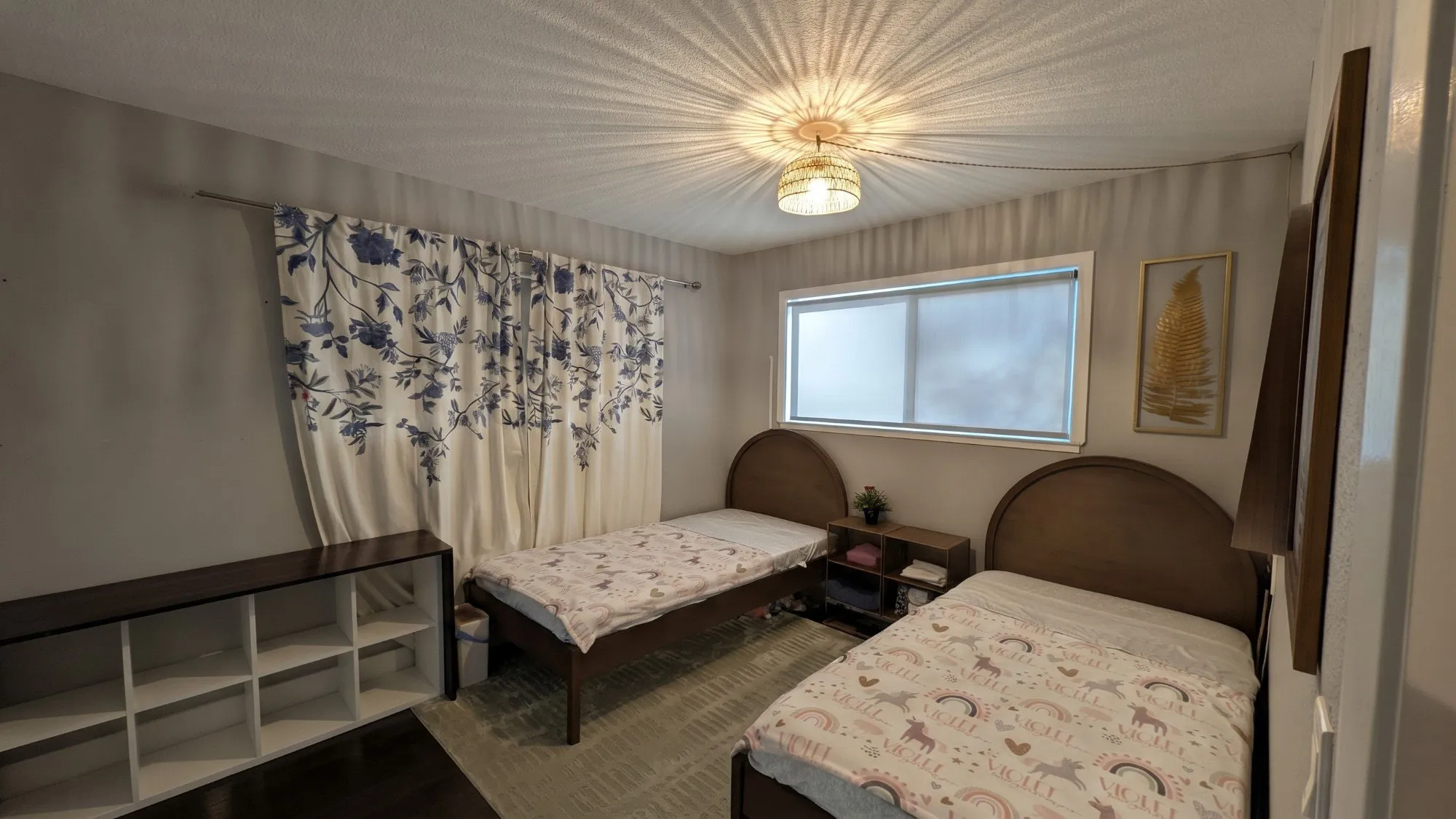 Twin room from the corner, with blue floral curtains