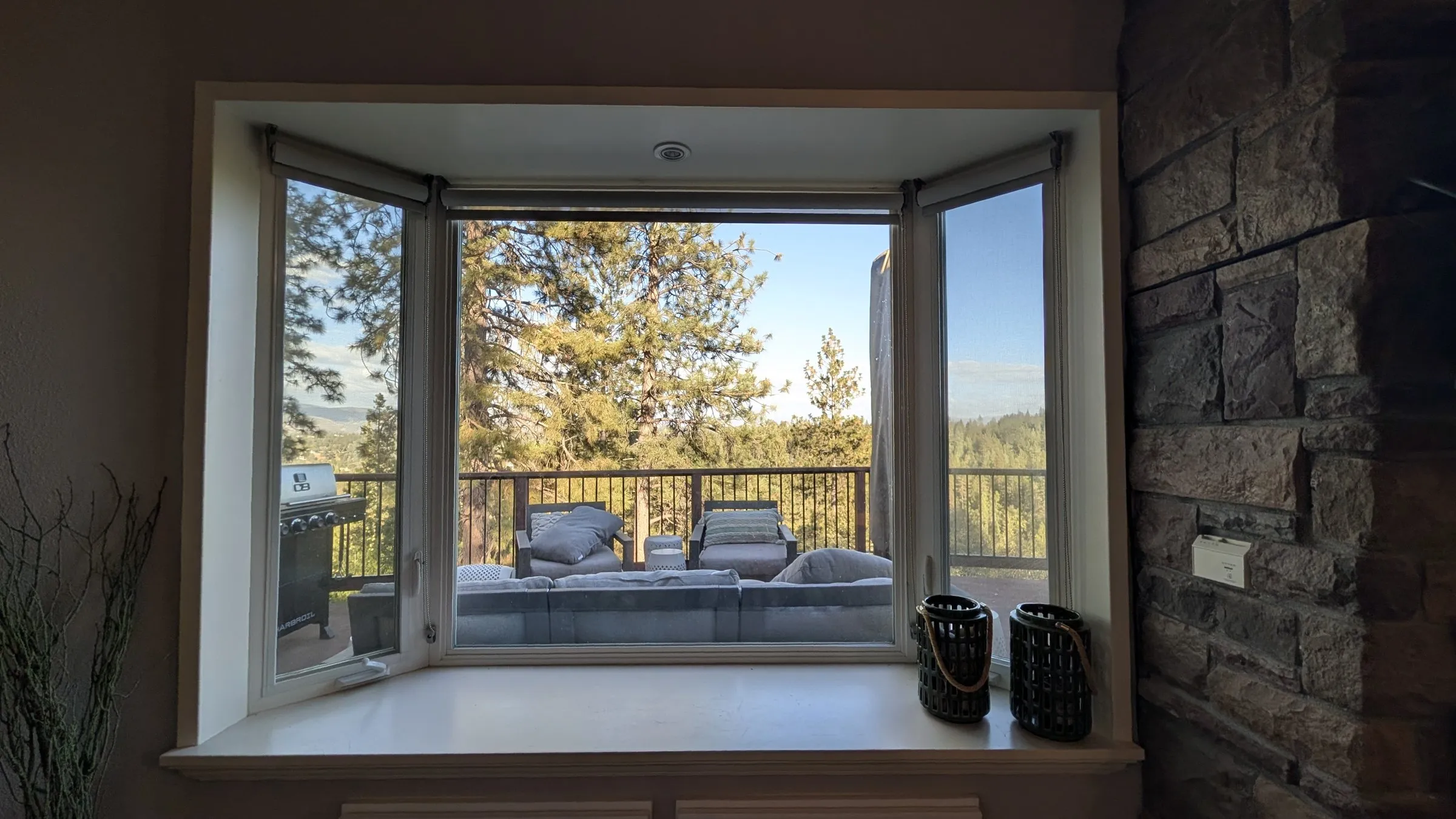 Bay window looking out onto the deck and forest