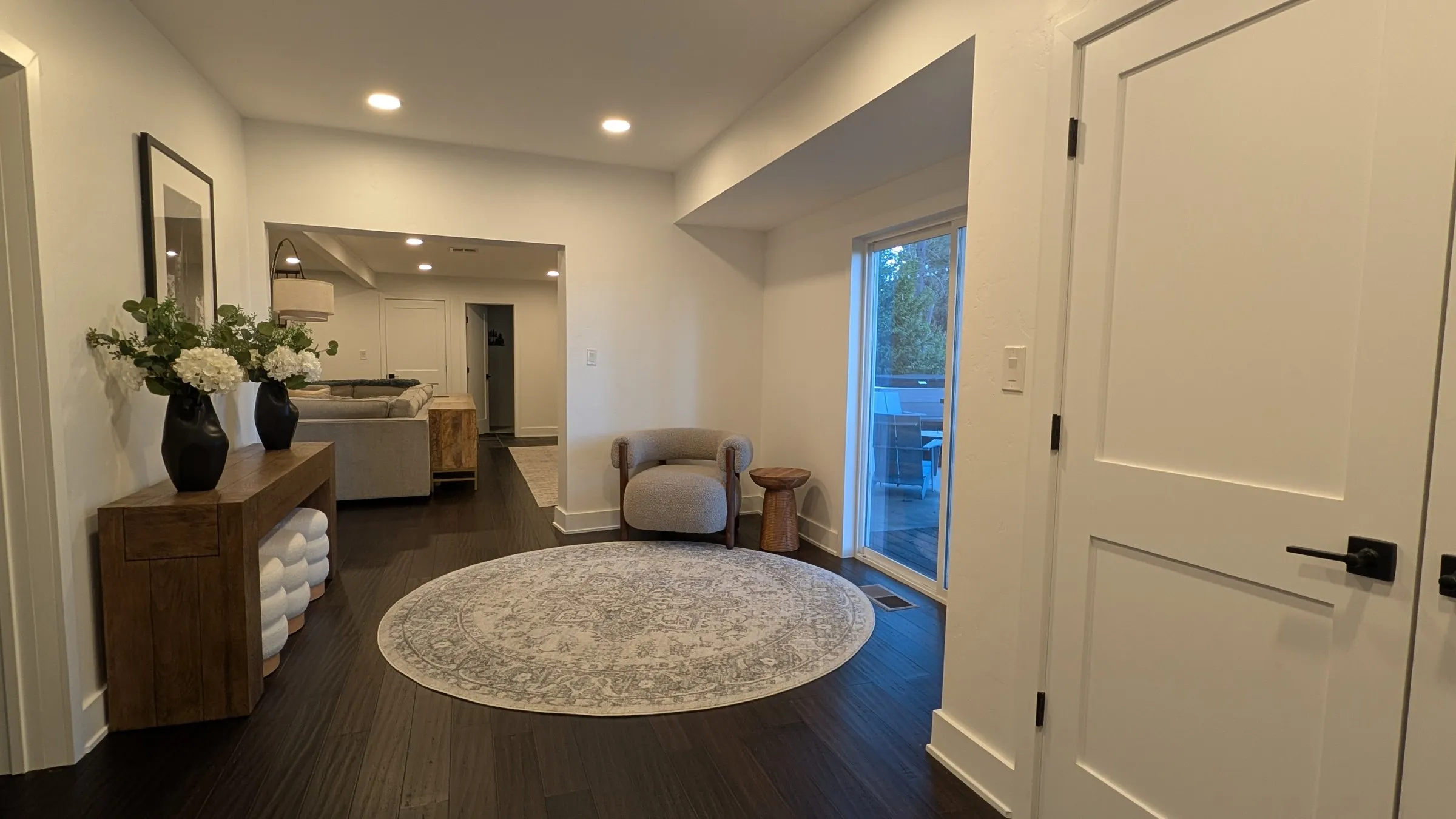Lower-level hall with console and round rug